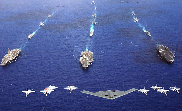 A B-2 Spirit and 16 other aircraft from the Air Force, Navy and Marine Corps fly over the USS Kitty Hawk, USS Ronald Reagan and USS Abraham Lincoln carrier strike groups in the western Pacific Ocean on Sunday, June 18, to kick off Exercise Valiant Shield 2006. The joint exercise consists of 28 naval vessels, more than 300 aircraft and approximately 20,000 servicemembers. (U.S. Navy photo/Chief Photographer's Mate Todd P. Cichonowicz)