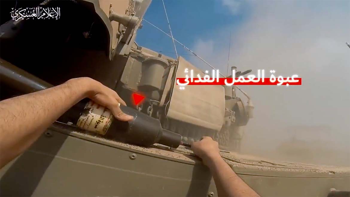 Hamas warrior attach bomb to Israeli tank, nov, 2023