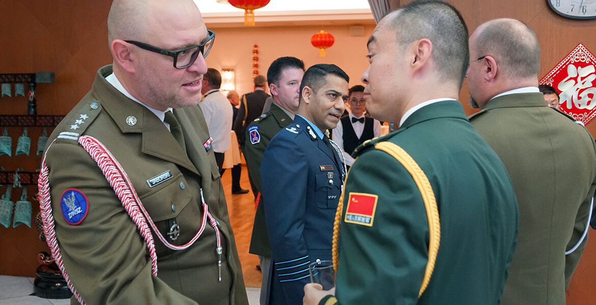 Colonel Adam Jaborski from Poland talks to Li Ke, Deputy Defence-attaché from China