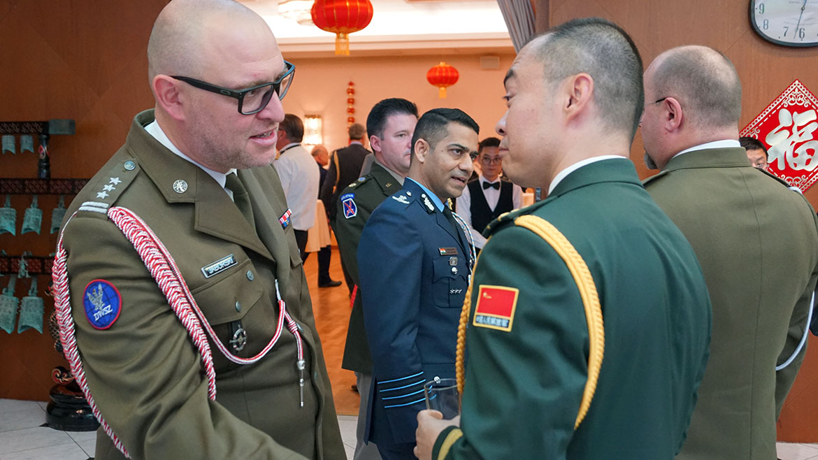 Colonel Adam Jaborski from Poland talks to Li Ke, Deputy Defence-attaché from China