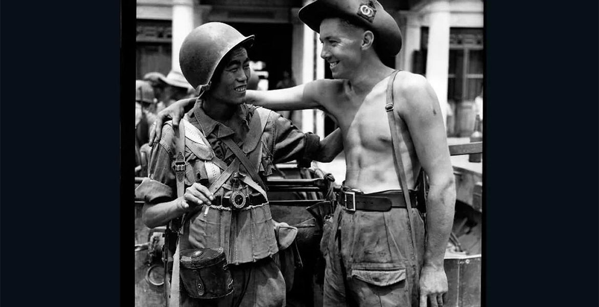British and Chinese soldiers exchange greetings when the Chinese and British troops met on the Mandalay Road, Burma on 30 March 1945.