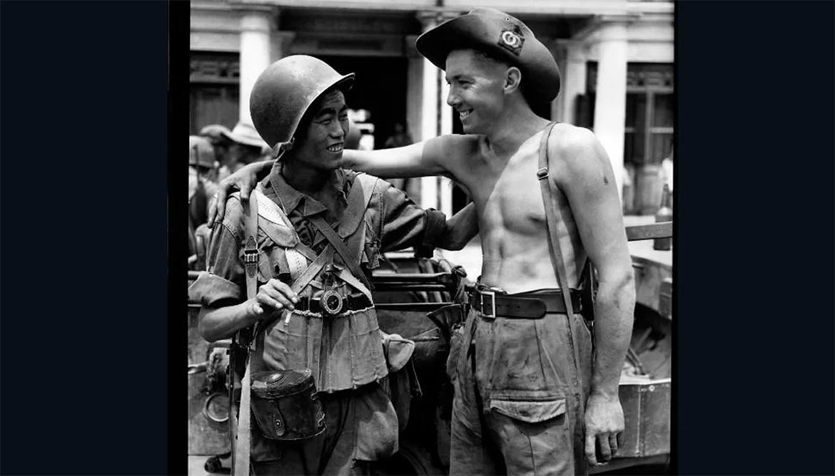 British and Chinese soldiers exchange greetings when the Chinese and British troops met on the Mandalay Road, Burma on 30 March 1945.